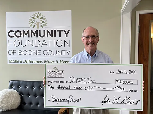 ILADD, Inc. staff member receiving a check from Community Foundation of Boone County